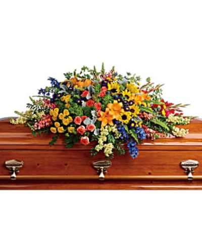 <div id="mark-1" class="m-pdp-tabs-marketing-description">Honor a bright, beautiful life with this colorful burst of hydrangea, roses, lilies and sunflowers that will add a rainbow of hope to the service.</div>
<div id="desc-1">
<ul>
<li>Green hydrangea, orange roses, yellow spray roses, orange asiatic lilies, red gladioli, large yellow sunflowers, blue delphinium, orange snapdragons, light yellow stock, purple matsumoto asters, and yellow button spray chrysanthemums are accented with green trick dianthus, blue eryngium, bupleurum, dusty miller and greenery.</li>
</ul>
</div>