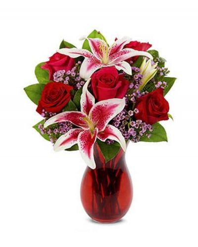 Celebrate your favorite Love Story. Make their heart skip a beat with this romantic bouquet of roses, stargazer lilies and waxflower artfully arranged in a gorgeous vase.