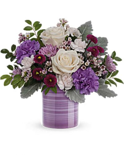 <div id="mark-3" class="m-pdp-tabs-marketing-description">
<div id="mark-3" class="m-pdp-tabs-marketing-description">Swirling with hand-painted bands of soft lavender, this sweet ceramic keepsake vase makes a marvelous Mother's Day gift filled with a bouquet of creamy roses and purple blooms.</div>
<p>&nbsp;</p>
<div id="desc-3">Crème roses, purple carnations, miniature light pink carnations, lavender cushion spray chrysanthemums, purple button spray chrysanthemums and pink waxflower are arranged with dusty miller and huckleberry.</div>
</div>
