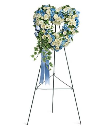 <div id="mark-1" class="m-pdp-tabs-marketing-description">This beautiful and petite, 16" heart-shaped wreath of sky blue hydrangea and snow white roses is a touching tribute to your love.</div>
<div id="desc-1">
<ul>
 	<li>This heartfelt arrangement features blue hydrangea, white spray roses, and variegated ivy.</li>
 	<li>Delivered on a wire easel.</li>
</ul>
</div>