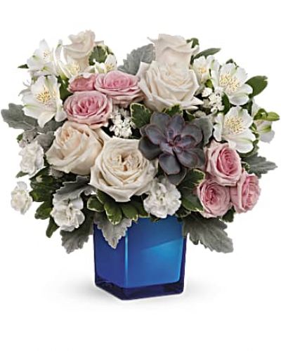 <div id="mark-3" class="m-pdp-tabs-marketing-description">Soft as a whisper, this enchanting bouquet of cream and pink roses looks oh-so-lovely in a glass cube that later becomes a comely candleholder.</div>
&nbsp;
<div id="desc-3">Crème roses, pink spray roses, white alstroemeria and miniature white carnations are arranged with variegated pittosporum, dusy miller, white sinuata statice and a large, potted green echeveria succulent.</div>