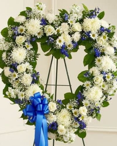 Let their special memories live on forever while expressing your deepest sympathy. This striking, heart-shaped tribute is crafted by our expert florists from fresh, beautiful blue and white blooms to help you offer your comfort and support during a difficult time. Traditionally sent directly to the funeral home by family members or friends and displayed on a stand.